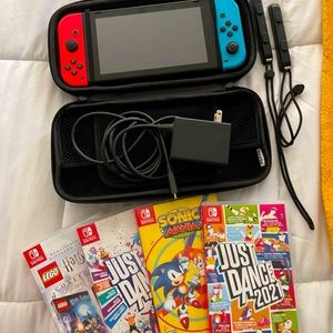Nintendo switch with carrying case and four games.